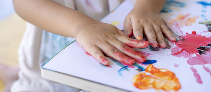 Childs hands doing finger painting